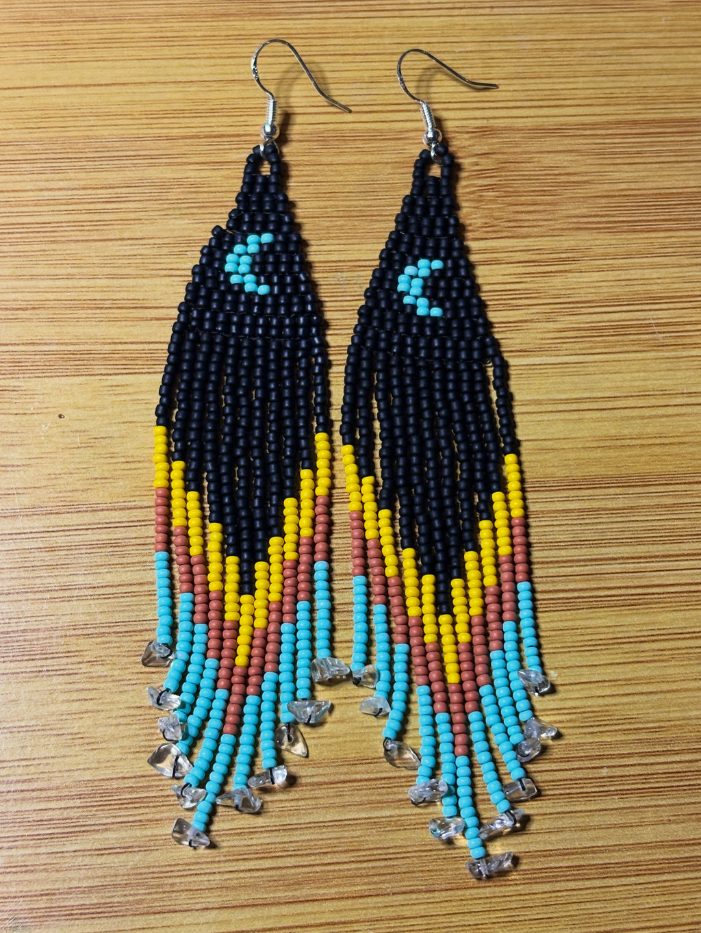 Red Road Moonrise beaded fringe earrings flat lay on wood surface