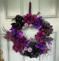 Custom spooky Halloween wreath with purple and black florals on door