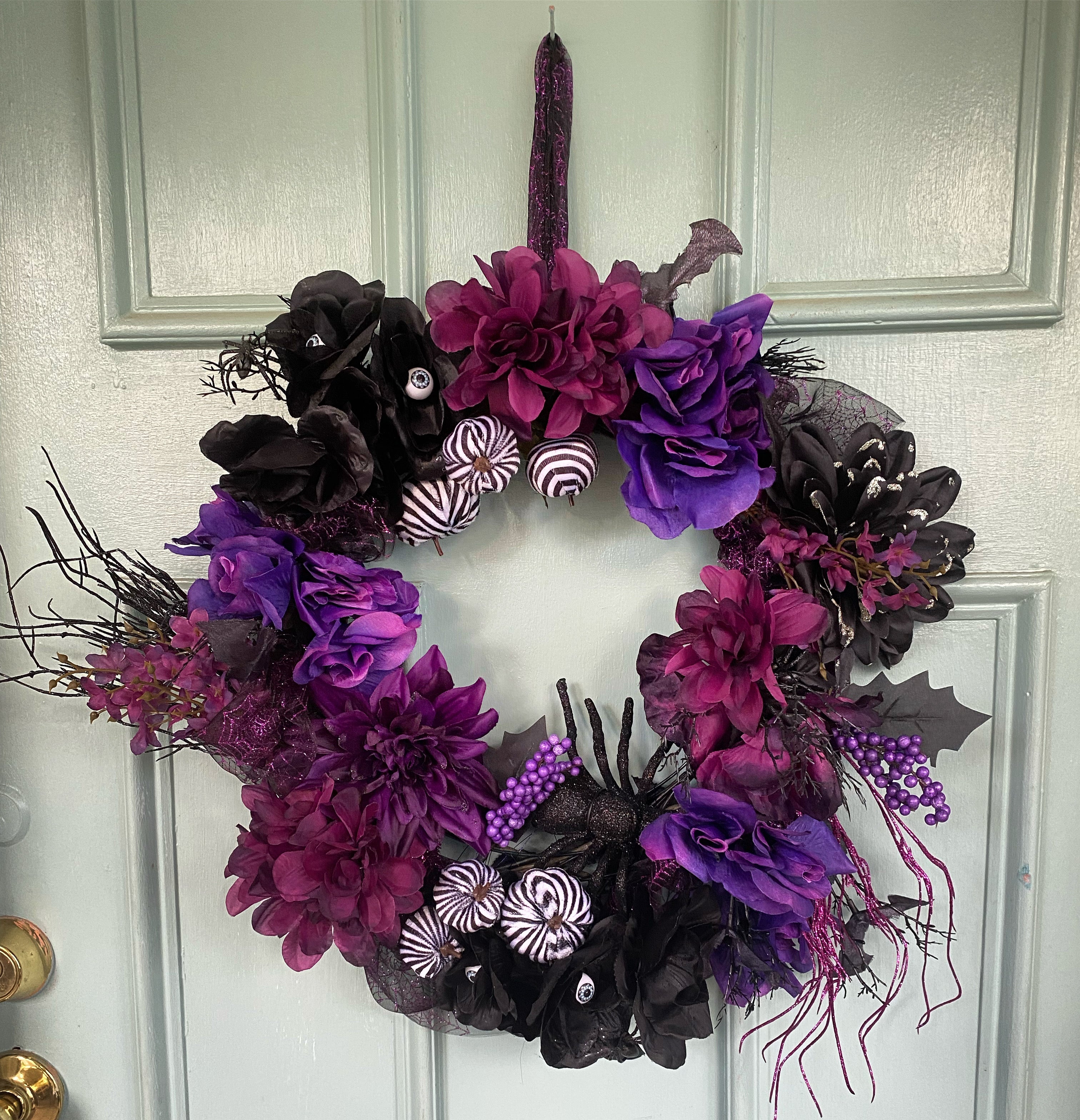 Custom spooky Halloween wreath with purple and black florals on door