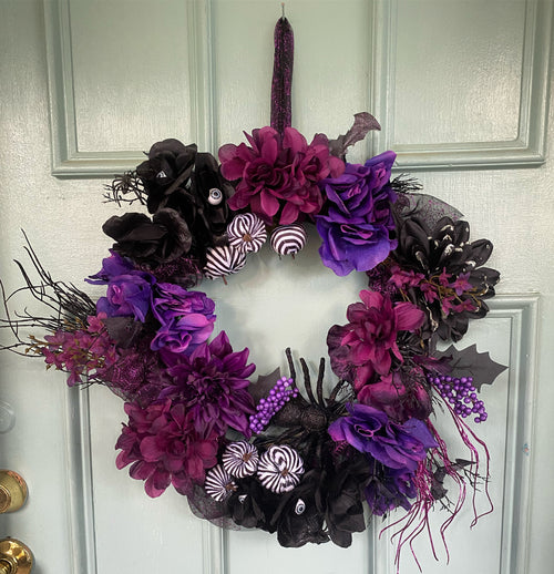 Custom spooky Halloween wreath with purple and black florals on door