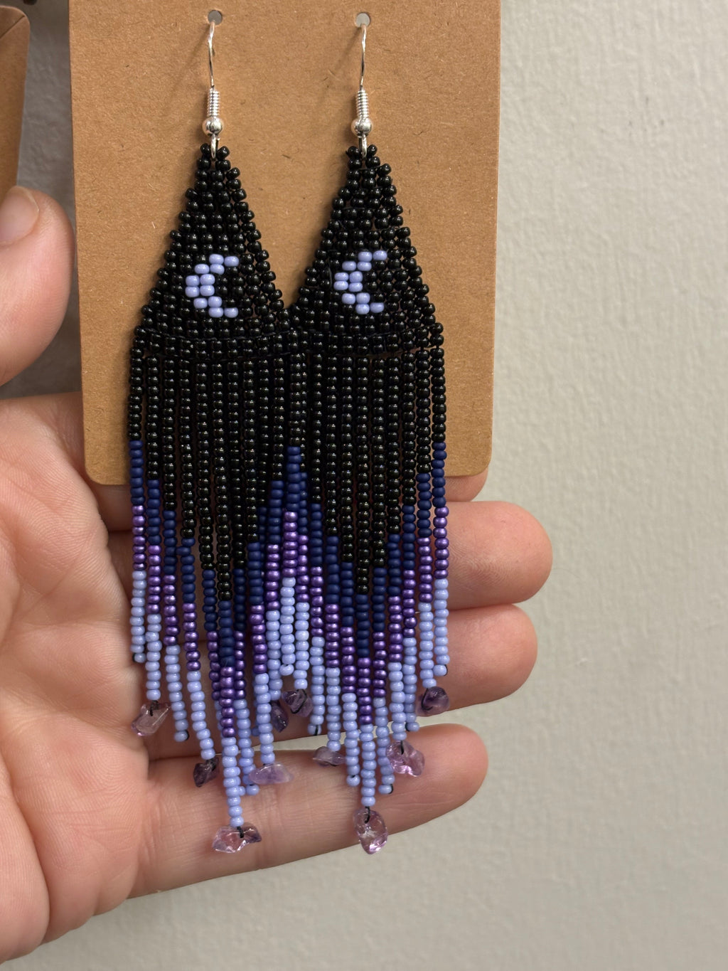 Purple Rain beaded fringe earrings held in hand showing full length