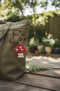 Beaded mushroom keychain lifestyle photo on a bag